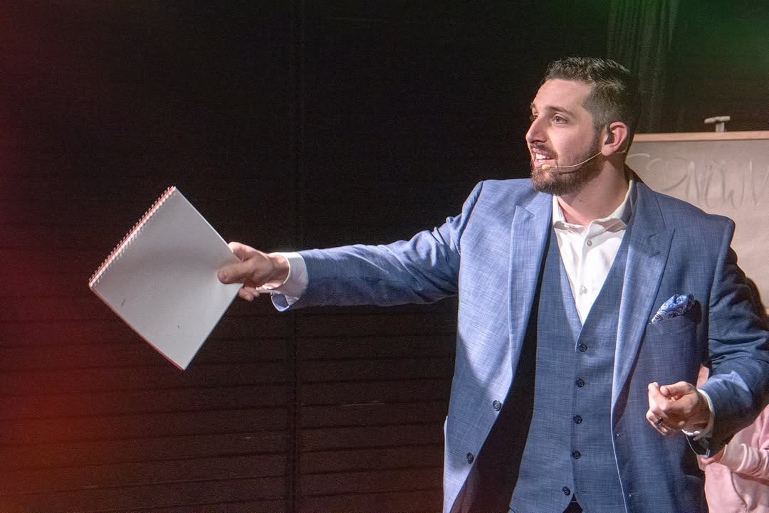 Daniel Nicholas on stage corporate event